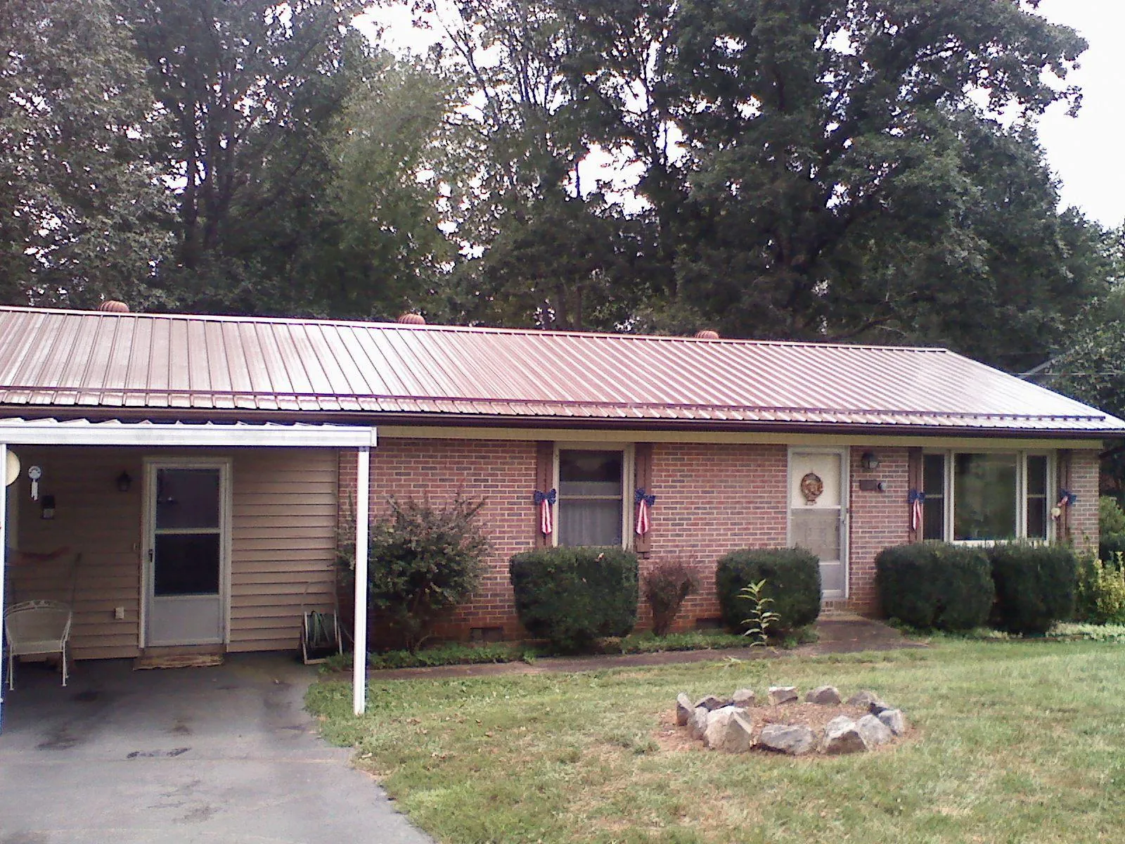 Bronze metal roof and carport on a brick ranch home — Roof Repair work by our crew in Tappan
